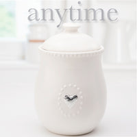 White Ceramic Canister w/Lid and  5 Interchangeable Metal Seasonal/Decor Magnets.